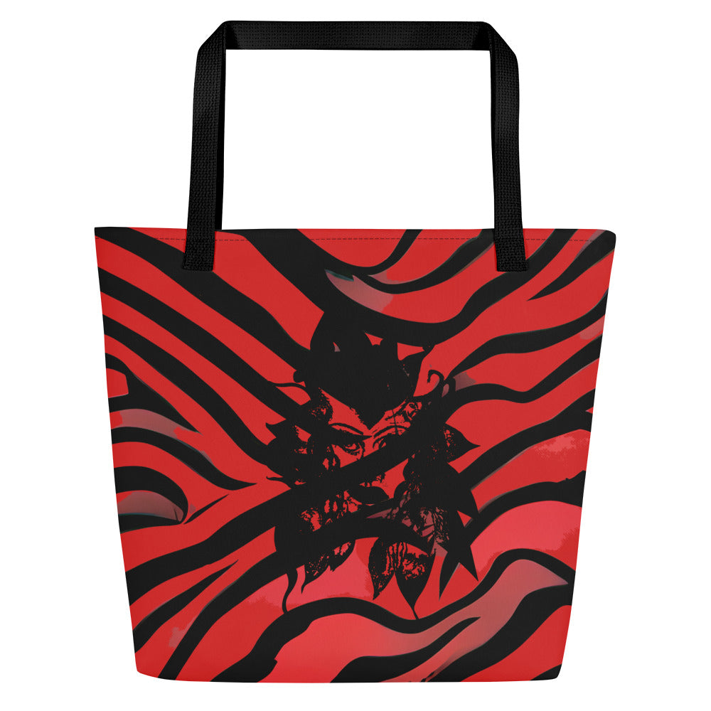 Large red and black tote bag from Kloe Store featuring a bold artistic face design and abstract swirling patterns, with black straps, perfect for trendy and functional everyday use, detail view.