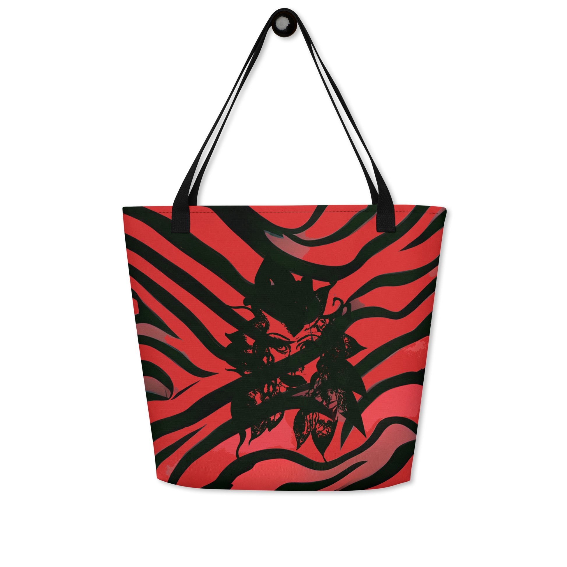 Large red and black tote bag from Kloe Store featuring a bold artistic face design and abstract swirling patterns, with black straps, perfect for trendy and functional everyday use, detail view.