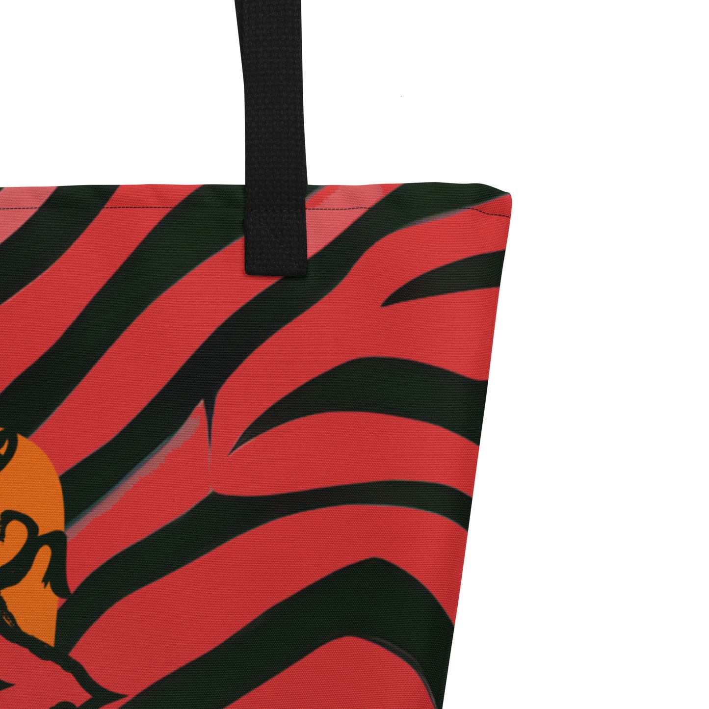 Large red and black tote bag from Kloe Store featuring a bold artistic face design and abstract swirling patterns, with black straps, perfect for trendy and functional everyday use, detail view.