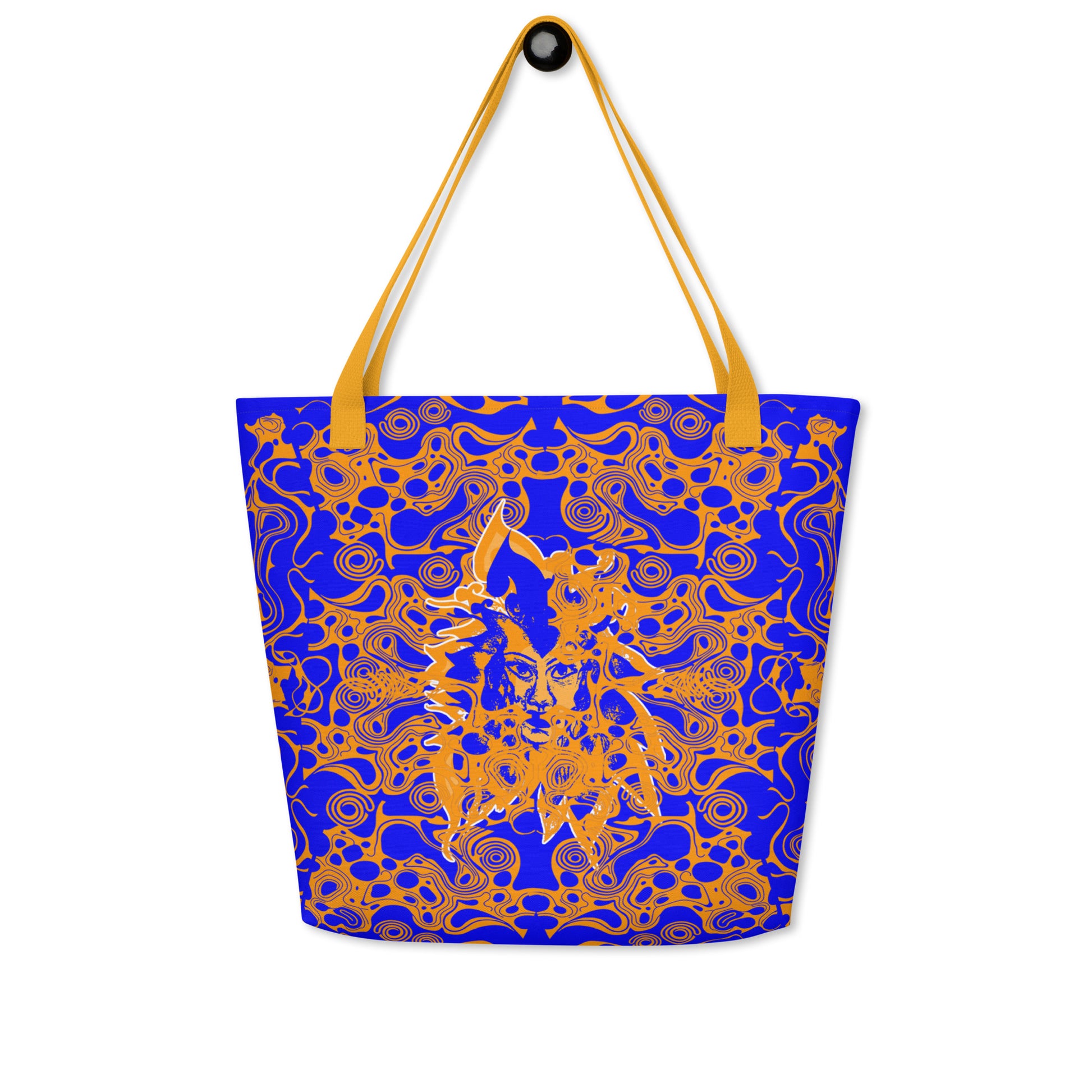 Bold blue and orange tote bag from Kloe Store featuring intricate abstract patterns and a central artistic face design, offering a stylish and edgy streetwear look.