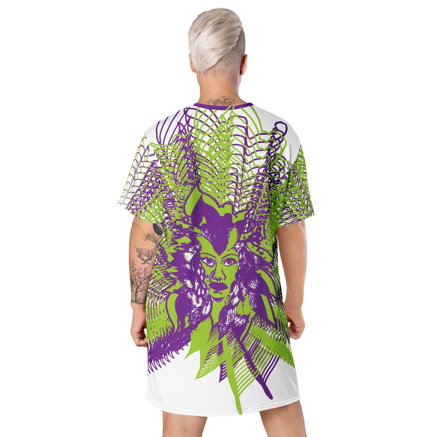 Back view of an all-over print K.L.O.E. t-shirt dress featuring bold purple and green geometric patterns radiating from a hand-drawn face design, representing individuality, self-expression, and modern bohemian style, worn by a model.