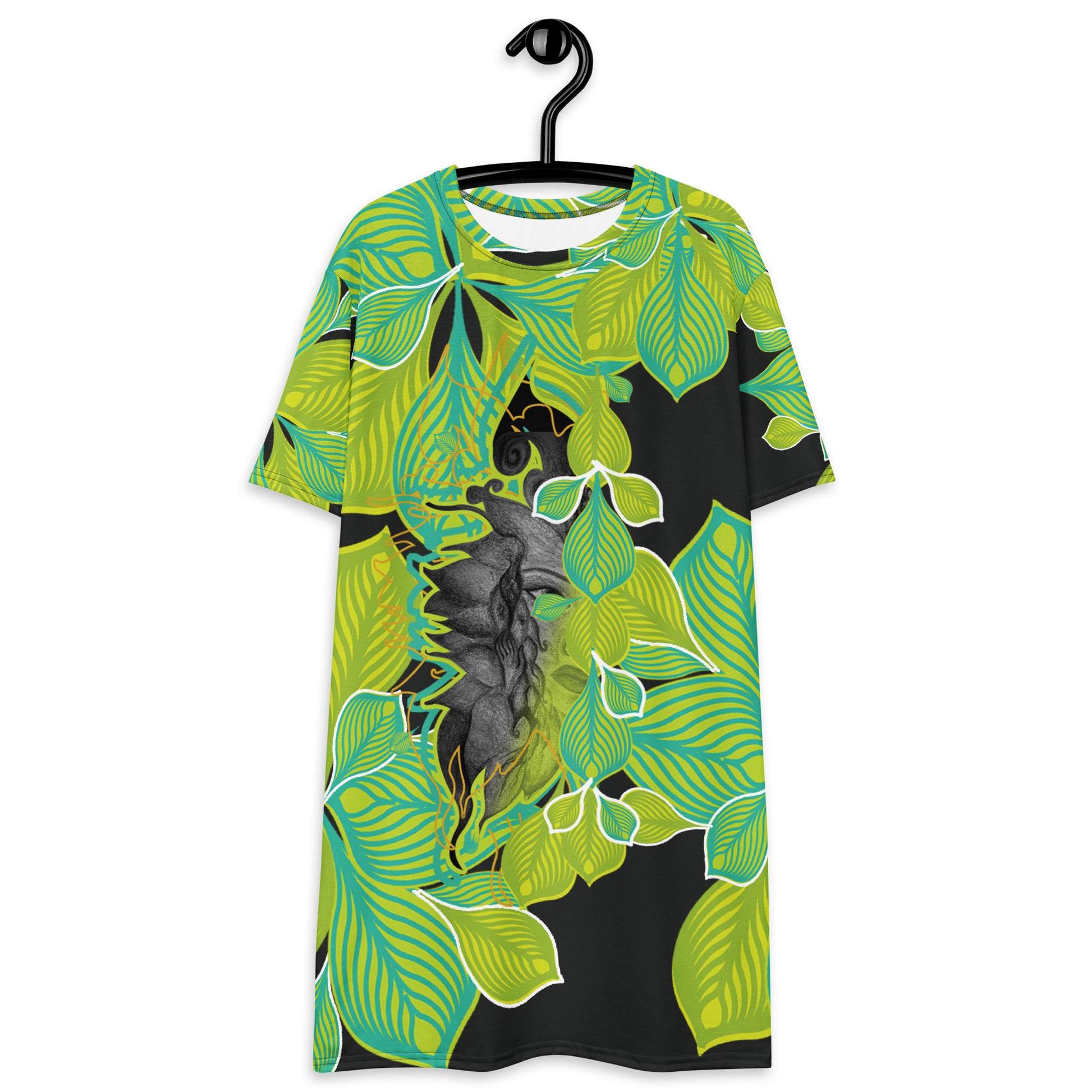 All-over print K.L.O.E. t-shirt dress featuring vibrant green and yellow leaf patterns framing a detailed black and gray hand-drawn face design, highlighting individuality, self-expression, and modern bohemian style.