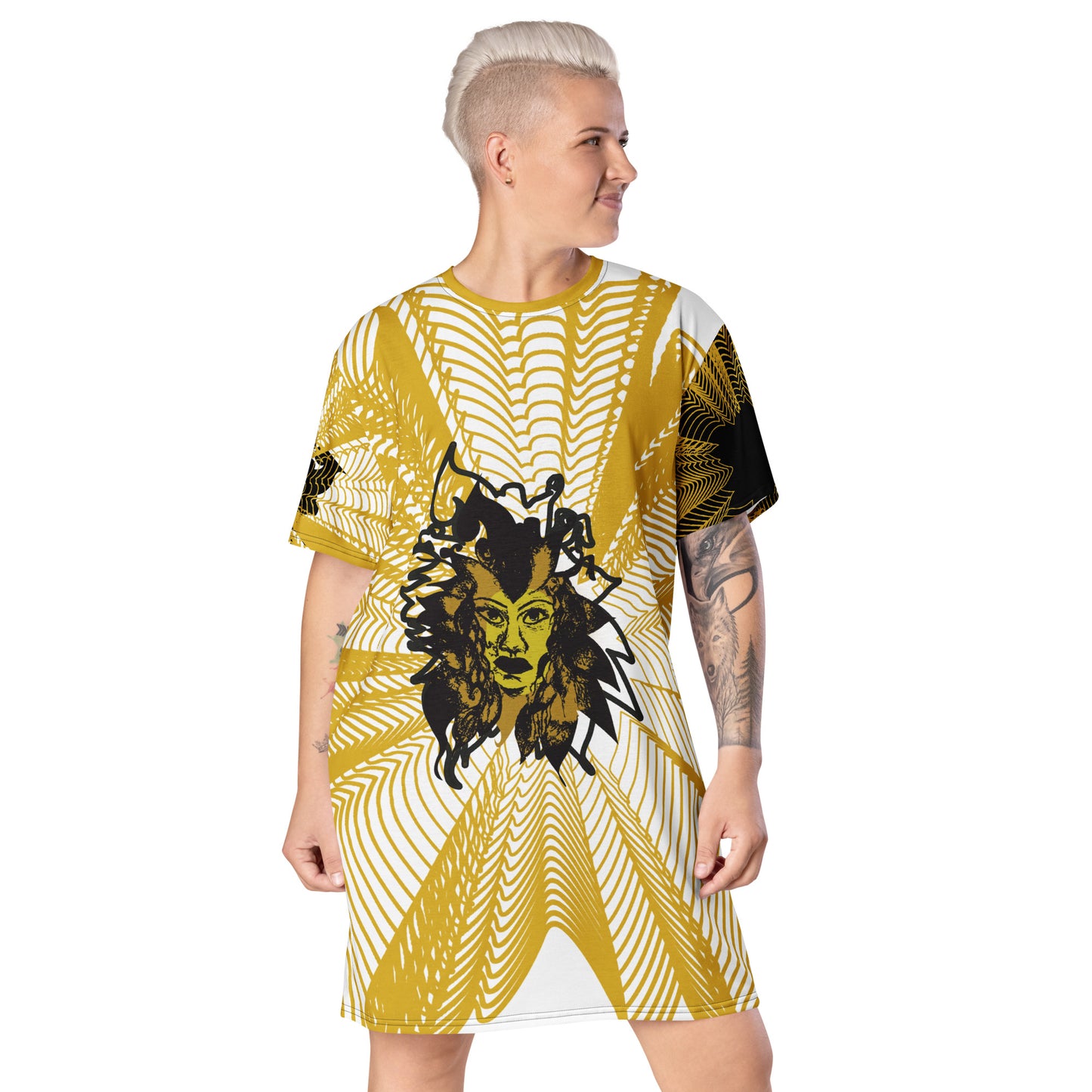 Front view of an all-over print K.L.O.E. t-shirt dress featuring a bold gold and white geometric pattern radiating from a central hand-drawn black and gold and yellow face design, embodying individuality, modern bohemian style, and self-expression, worn by a model.