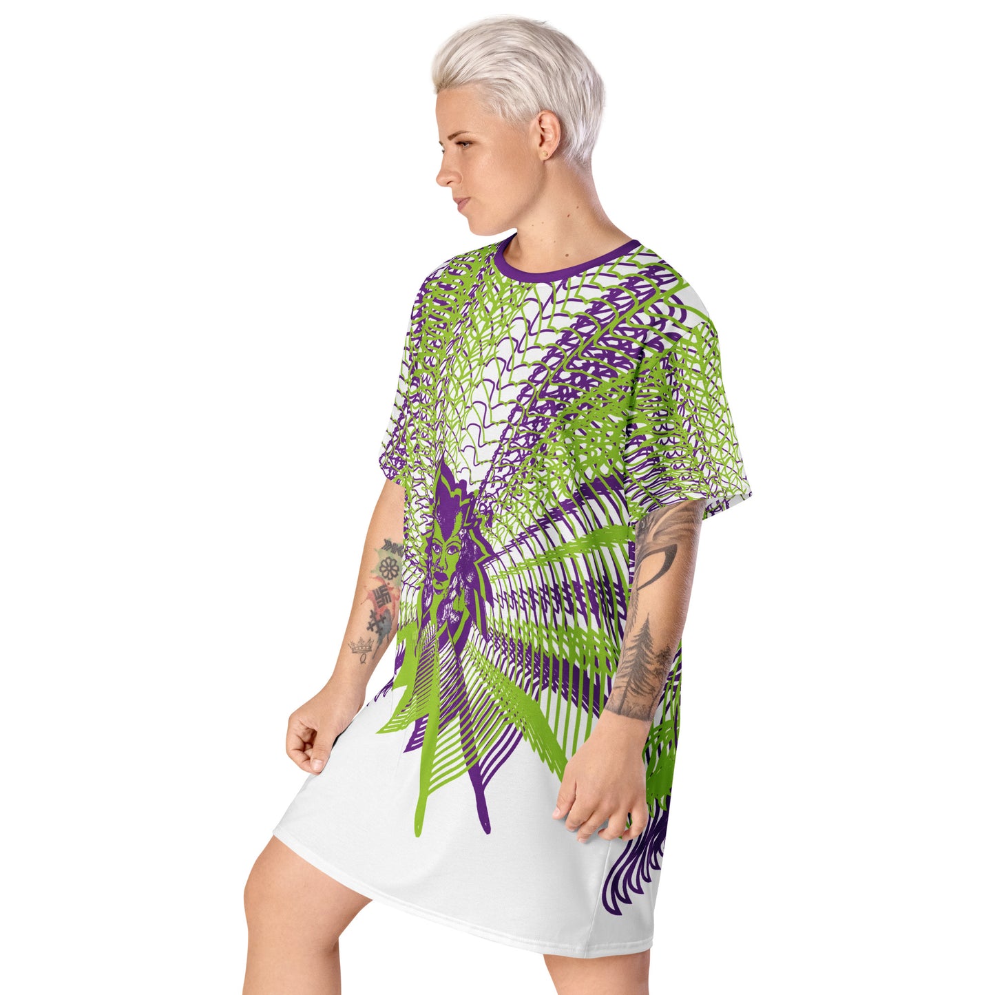 Front view of an all-over print K.L.O.E. t-shirt dress featuring vibrant purple and green geometric patterns radiating from a central hand-drawn face design, embodying individuality, self-expression, and modern bohemian fashion, worn by a model.