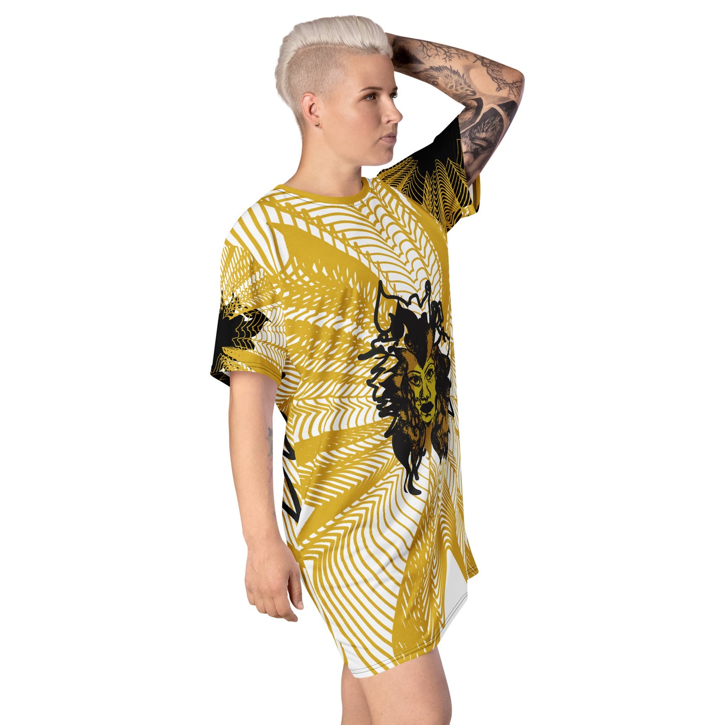 Side view of an all-over print K.L.O.E. t-shirt dress featuring a bold gold and white geometric pattern radiating from a central hand-drawn black and gold and yellow face design, embodying individuality, modern bohemian style, and self-expression, worn by a model.