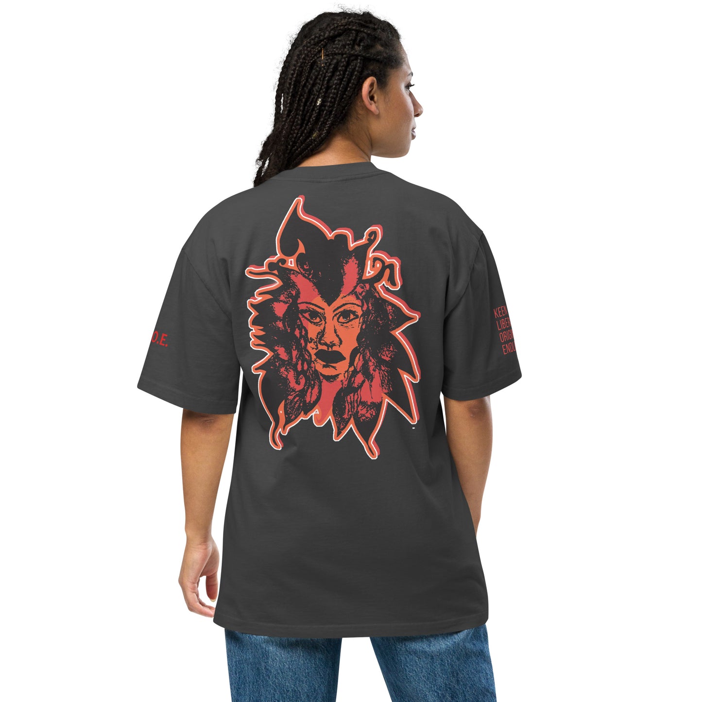 Black unisex oversized t-shirt featuring a striking red, hand-drawn face graphic on the back and front, inspired by global artistry and expressive fashion. The sleeve showcases ‘KEEN, LIBERATED, ORIGINAL, ENDLESS,’ embodying modern boho style and empowering individuality. A statement piece for those embracing contemporary, culturally inspired fashion.