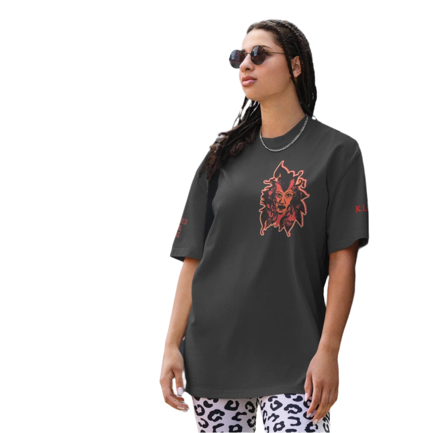 Black unisex oversized t-shirt featuring a striking red, hand-drawn face graphic on the back and front, inspired by global artistry and expressive fashion. The sleeve showcases ‘KEEN, LIBERATED, ORIGINAL, ENDLESS,’ embodying modern boho style and empowering individuality. A statement piece for those embracing contemporary, culturally inspired fashion.