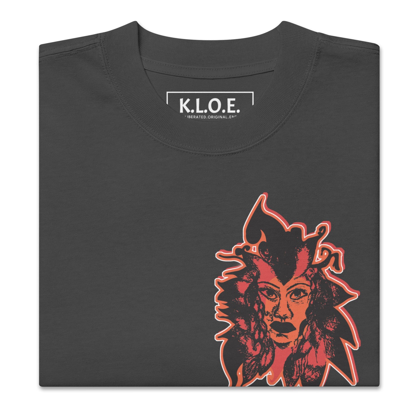 Black unisex oversized t-shirt featuring a striking red, hand-drawn face graphic on the back and front, inspired by global artistry and expressive fashion. The sleeve showcases ‘KEEN, LIBERATED, ORIGINAL, ENDLESS,’ embodying modern boho style and empowering individuality. A statement piece for those embracing contemporary, culturally inspired fashion.