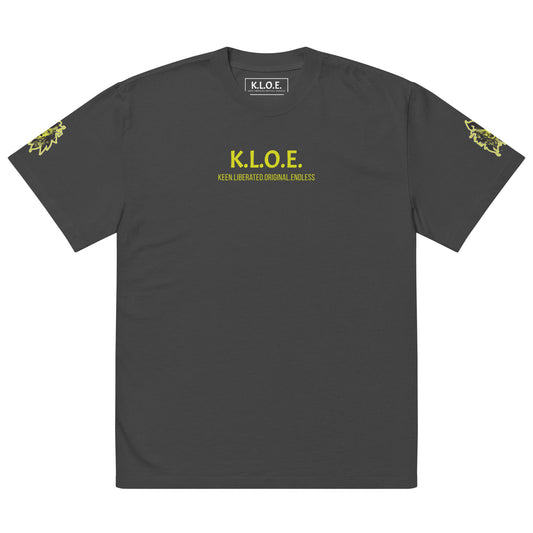 Black unisex oversized t-shirt with a bold yellow hand-drawn face graphic on the back, embodying culturally inspired fashion and modern boho style. The front features the K.L.O.E. logo and ‘KEEN, LIBERATED, ORIGINAL, ENDLESS’ text, celebrating individuality and expressive fashion for a contemporary, liberated lifestyle.