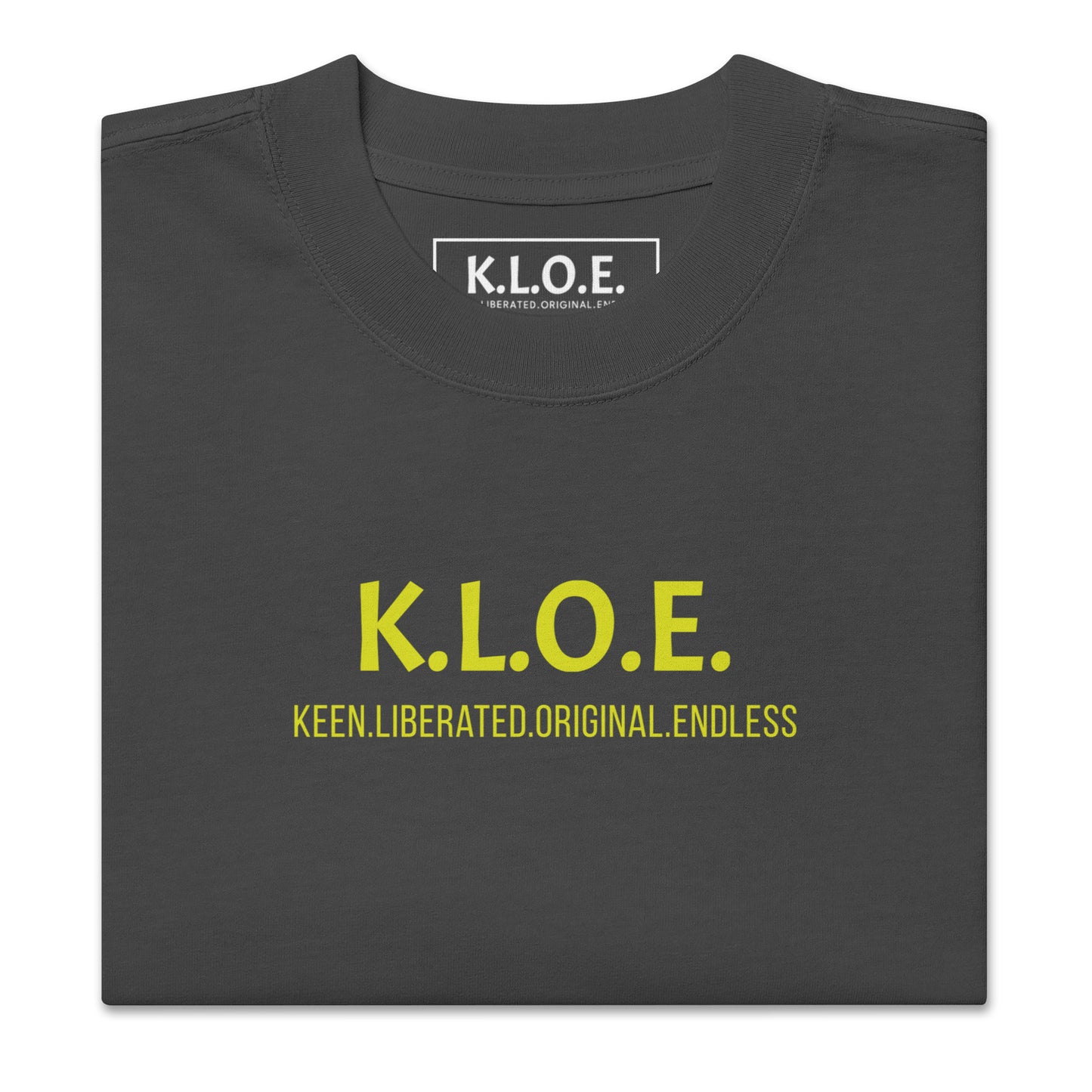 Black unisex oversized t-shirt with a bold yellow hand-drawn face graphic on the back, embodying culturally inspired fashion and modern boho style. The front features the K.L.O.E. logo and ‘KEEN, LIBERATED, ORIGINAL, ENDLESS’ text, celebrating individuality and expressive fashion for a contemporary, liberated lifestyle.