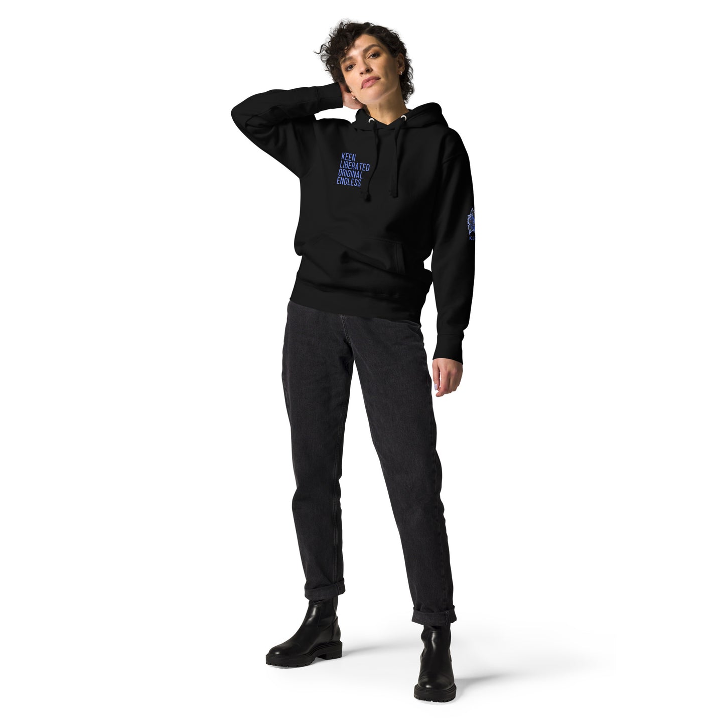 Black unisex K.L.O.E hoodie featuring a bold, hand-drawn blue graphic of an expressive face on the back, inspired by global artistry and modern boho style. The front showcases ‘KEEN, LIBERATED, ORIGINAL, ENDLESS’ text, celebrating individuality and self-expression. A contemporary fashion statement for those embracing artistic clothing and culturally inspired style.