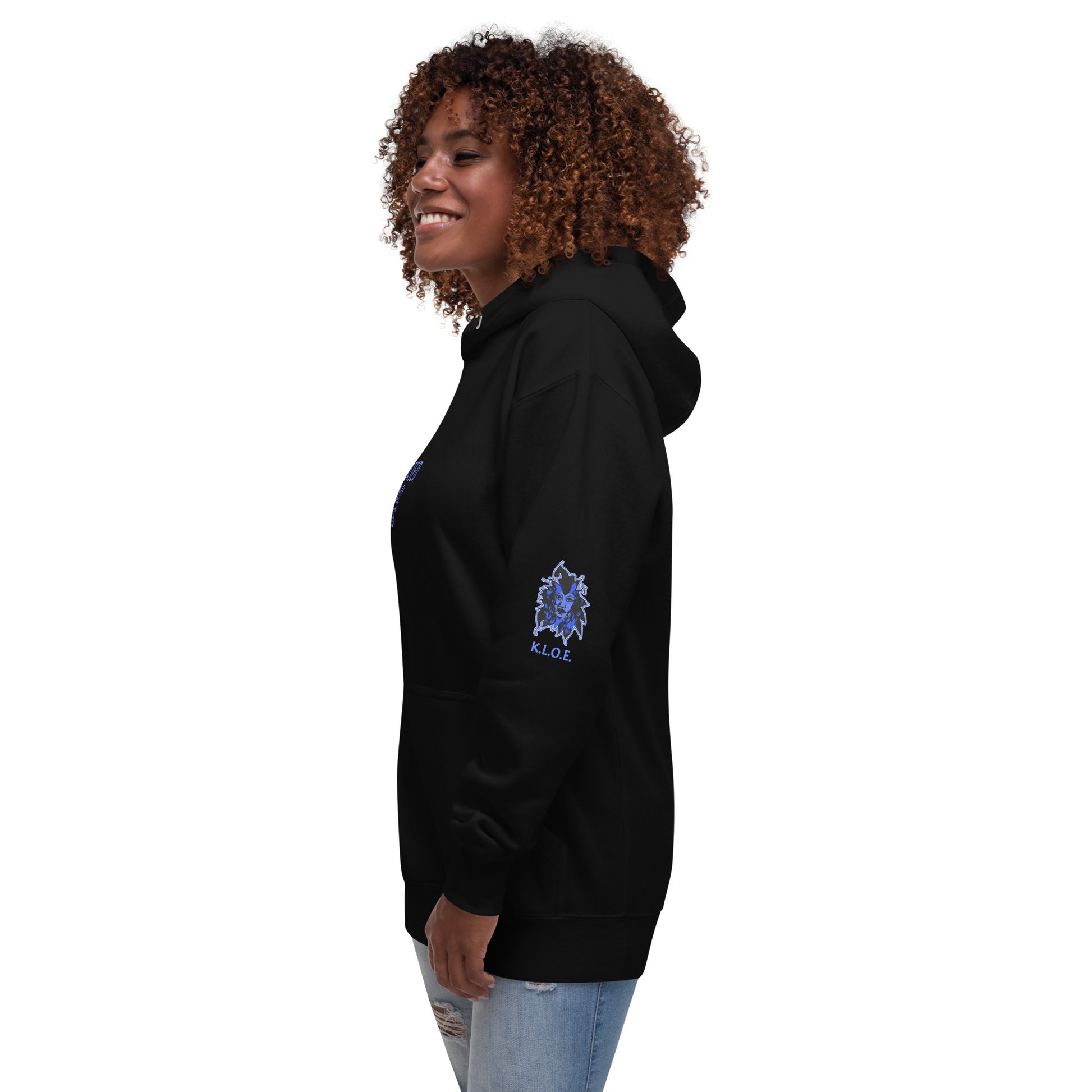 Black unisex K.L.O.E hoodie featuring a bold, hand-drawn blue graphic of an expressive face on the back, inspired by global artistry and modern boho style. The front showcases ‘KEEN, LIBERATED, ORIGINAL, ENDLESS’ text, celebrating individuality and self-expression. A contemporary fashion statement for those embracing artistic clothing and culturally inspired style, on a model.