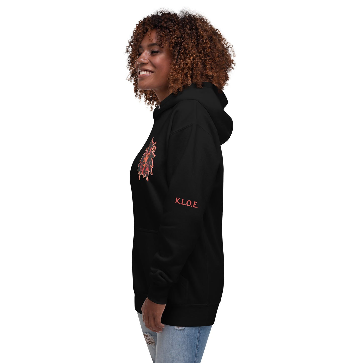 Black unisex hoodie featuring a striking red, hand-drawn face graphic on the back and front, inspired by global artistry and expressive fashion. The sleeve showcases ‘KEEN, LIBERATED, ORIGINAL, ENDLESS,’ embodying modern boho style and empowering individuality. A statement piece for those embracing contemporary, culturally inspired fashion.