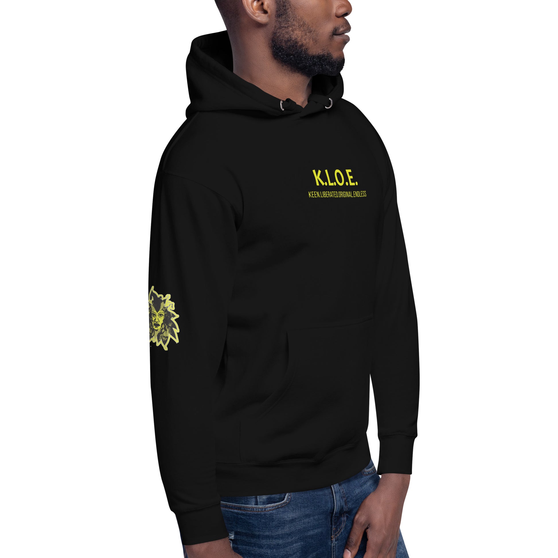 Black unisex hoodie with a bold yellow hand-drawn face graphic on the back, embodying culturally inspired fashion and modern boho style. The front features the K.L.O.E. logo and ‘KEEN, LIBERATED, ORIGINAL, ENDLESS’ text, celebrating individuality and expressive fashion for a contemporary, liberated lifestyle.