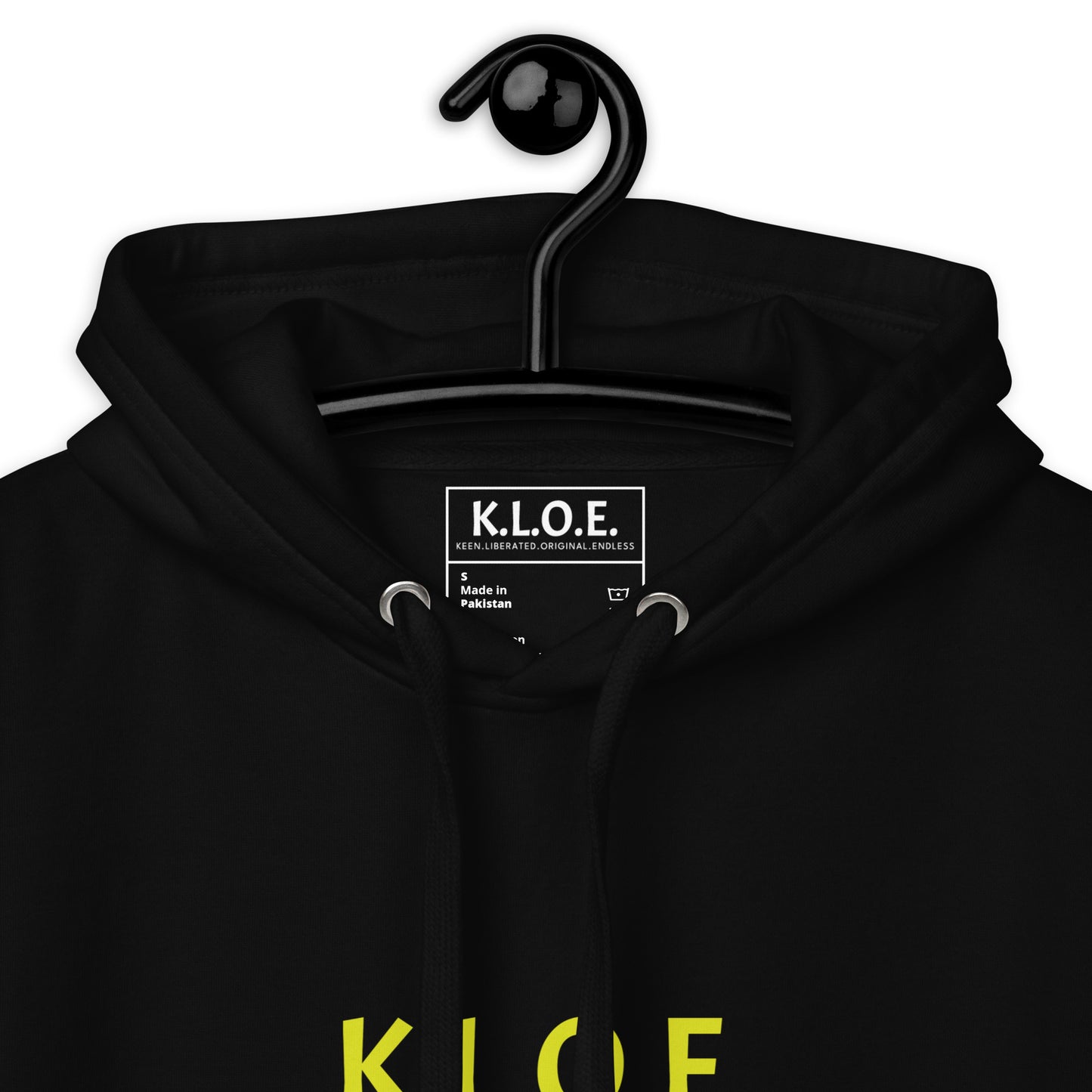 Black unisex hoodie with a bold yellow hand-drawn face graphic on the back, embodying culturally inspired fashion and modern boho style. The front features the K.L.O.E. logo and ‘KEEN, LIBERATED, ORIGINAL, ENDLESS’ text, celebrating individuality and expressive fashion for a contemporary, liberated lifestyle.