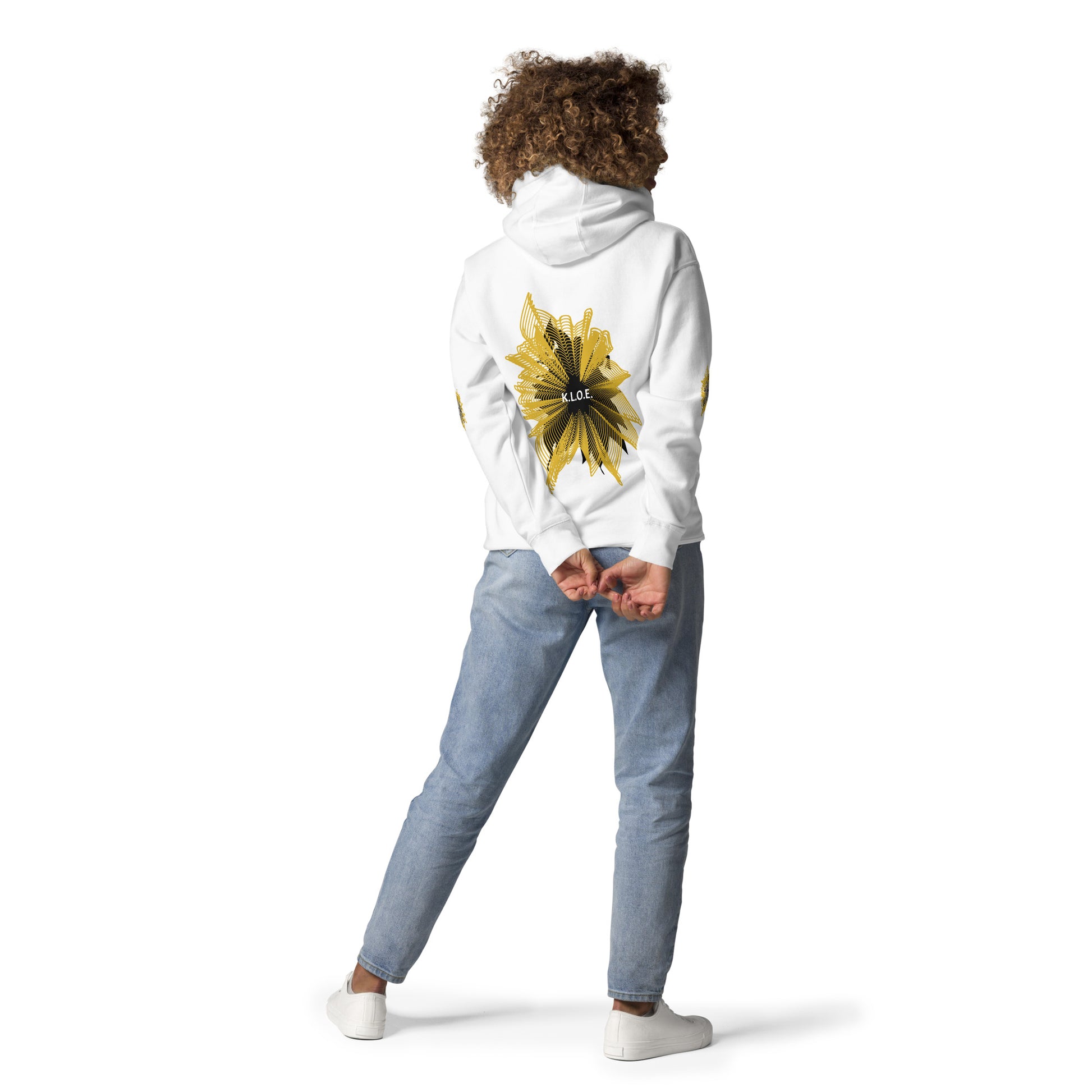 Back view of a white K.L.O.E. hoodie showcasing a bold hand-drawn golden abstract sunburst design with black accents and the K.L.O.E. logo—an artistic and empowering piece of culturally inspired, handcrafted fashion that blends modern boho style with expressive apparel, celebrating individuality and self-expression, worn by a model.