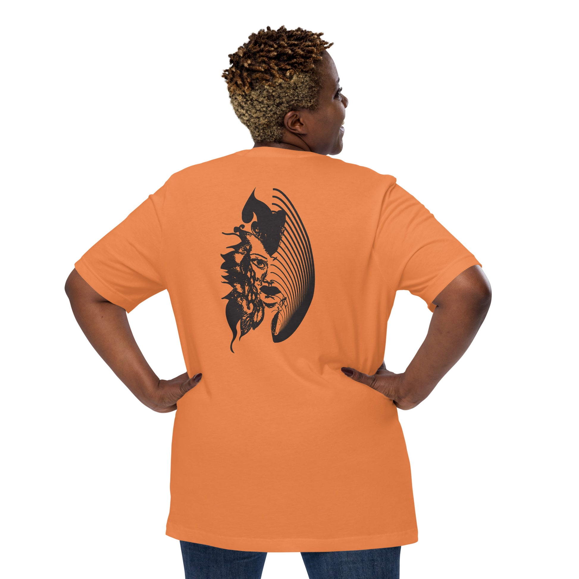 Back view of an orange K.L.O.E. T-shirt showcasing a culturally inspired, hand-drawn black design featuring a bold, expressive face intertwined with flowing, abstract patterns, embodying artistic self-expression and modern bohemian style fashion, on a model.