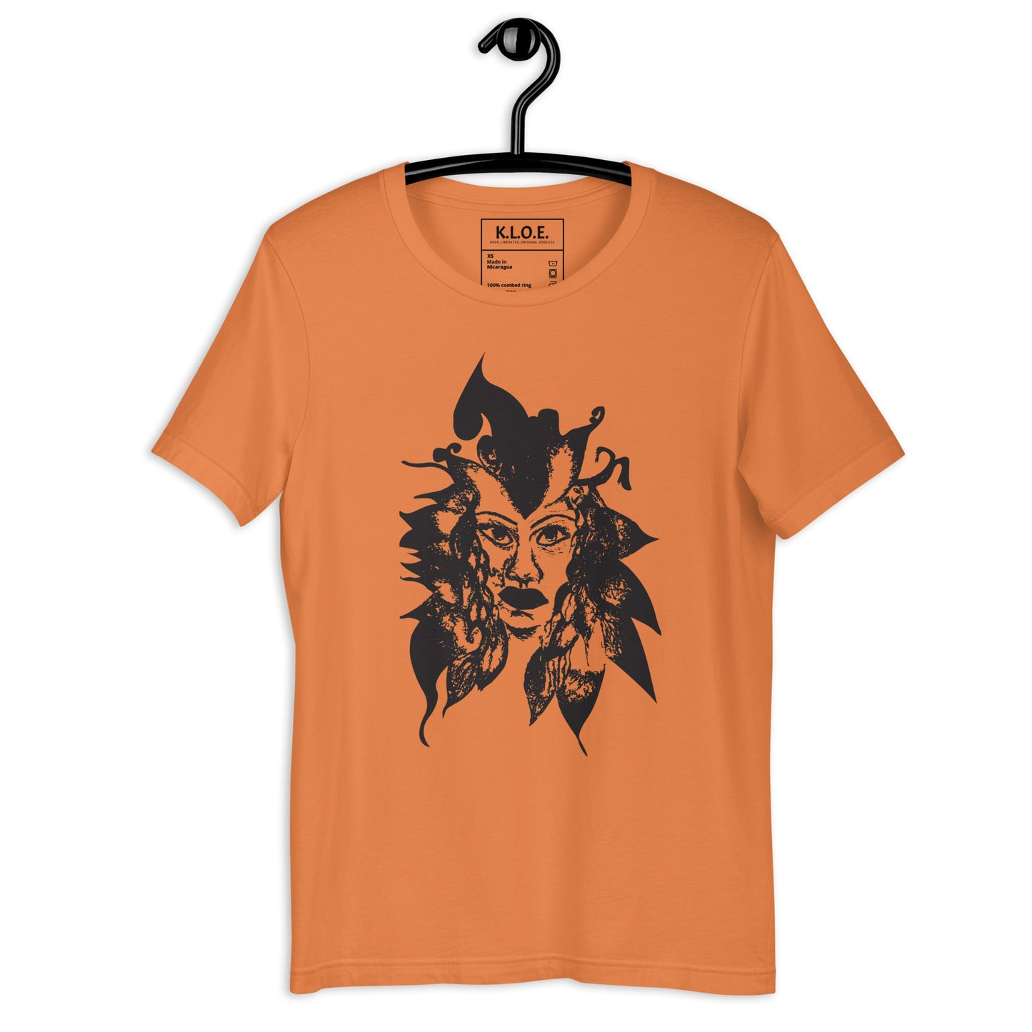 Orange K.L.O.E. T-shirt featuring a culturally inspired, hand-drawn black graphic of a bold, expressive face surrounded by intricate details, celebrating individuality and artistic self-expression in modern bohemian style fashion.