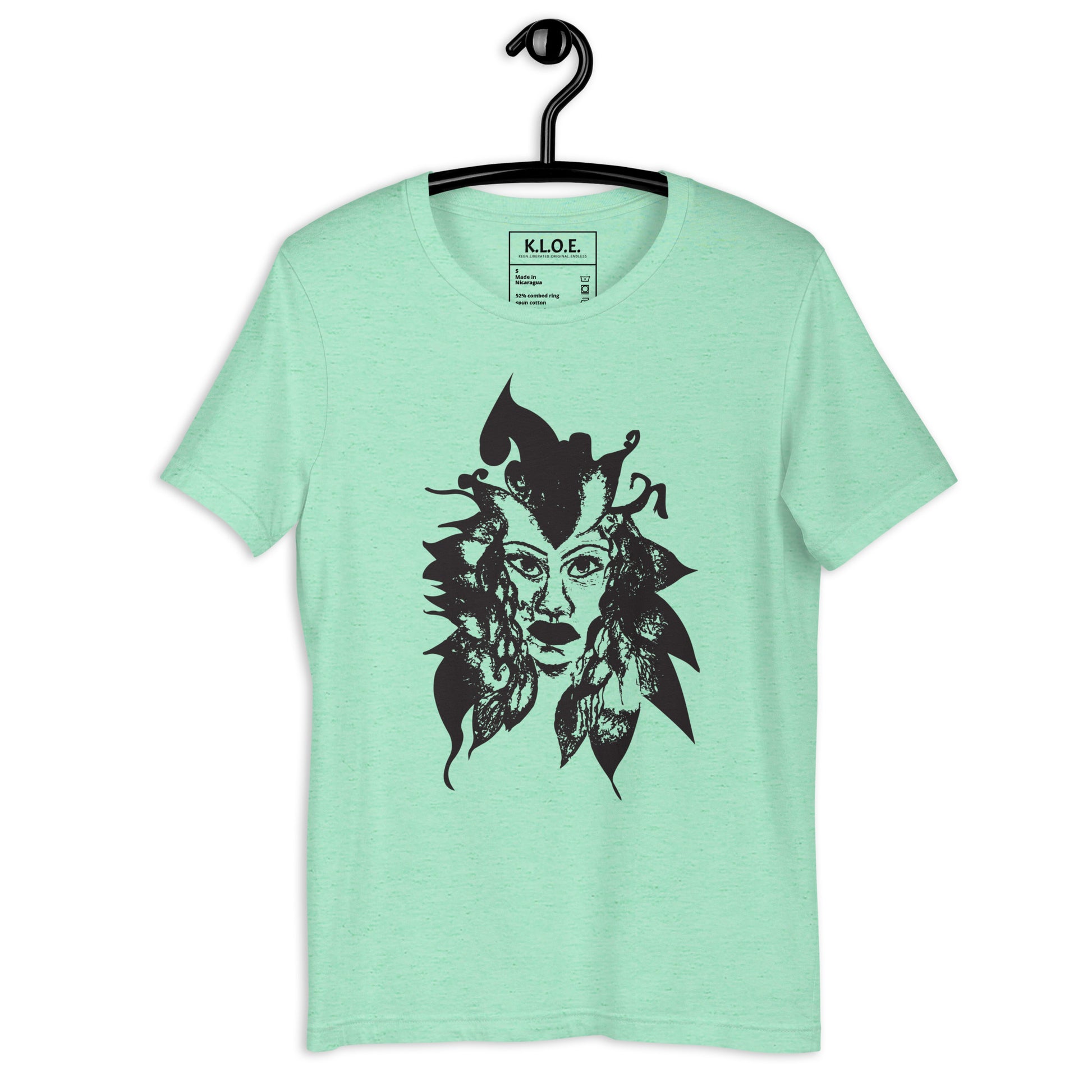 Mint K.L.O.E. T-shirt featuring a culturally inspired, hand-drawn black graphic of a bold, expressive face surrounded by intricate details, celebrating individuality and artistic self-expression in modern bohemian style fashion.