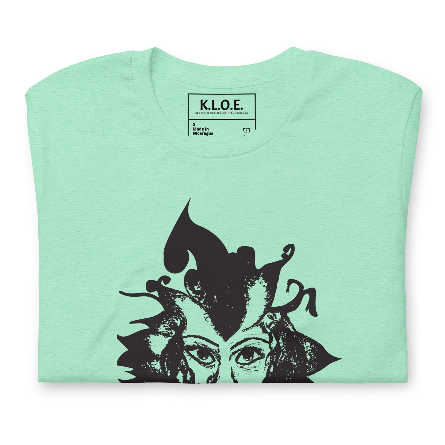 The inside label view of the mint K.L.O.E. T-shirt featuring a culturally inspired, hand-drawn black graphic of a bold, expressive face surrounded by intricate details, celebrating individuality and artistic self-expression in modern bohemian style fashion.