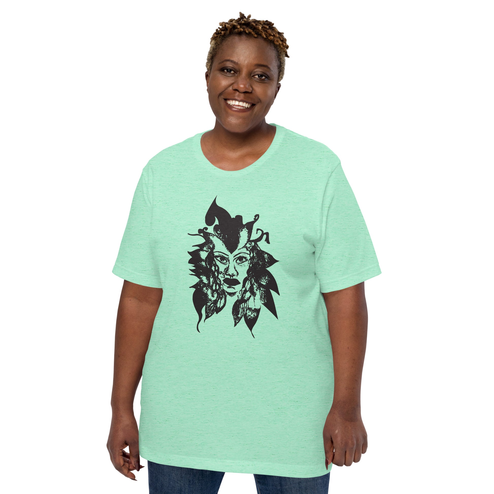 The model wearing mint K.L.O.E. T-shirt featuring a culturally inspired, hand-drawn black graphic of a bold, expressive face surrounded by intricate details, celebrating individuality and artistic self-expression in modern bohemian style fashion.