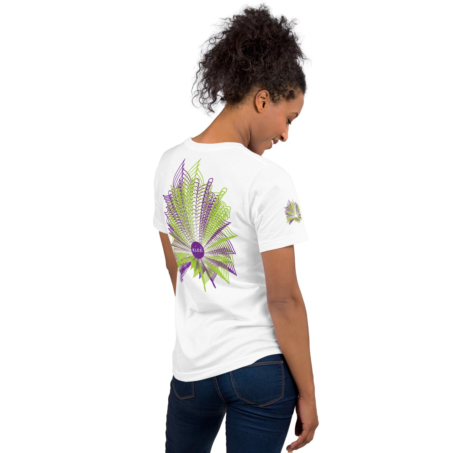 Back view of a white K.L.O.E. T-shirt featuring a vibrant geometric design in purple and green, radiating outward in intricate patterns, with the K.L.O.E. logo at the center, embodying artistic self-expression and modern bohemian fashion, worn by a model.