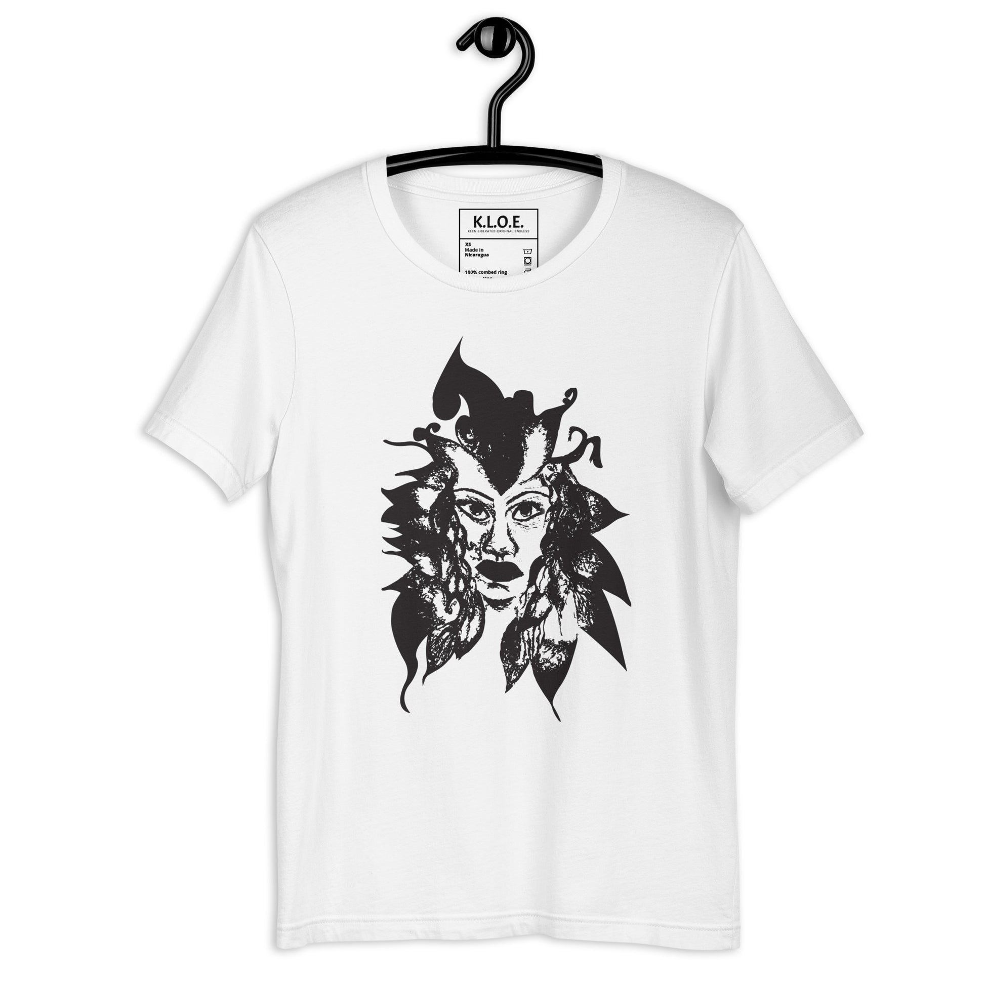 White K.L.O.E. T-shirt featuring a culturally inspired, hand-drawn black graphic of a bold, expressive face surrounded by intricate details, celebrating individuality and artistic self-expression in modern bohemian style fashion.