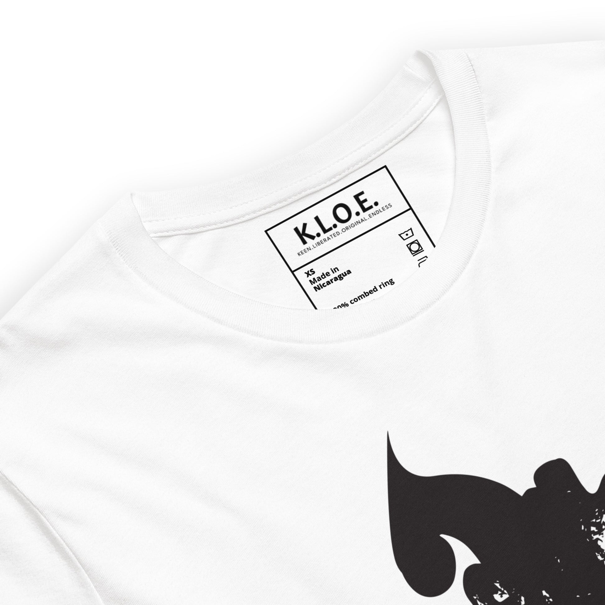 The view of the inside label of the white K.L.O.E. T-shirt featuring a culturally inspired, hand-drawn black graphic of a bold, expressive face surrounded by intricate details, celebrating individuality and artistic self-expression in modern bohemian style fashion.