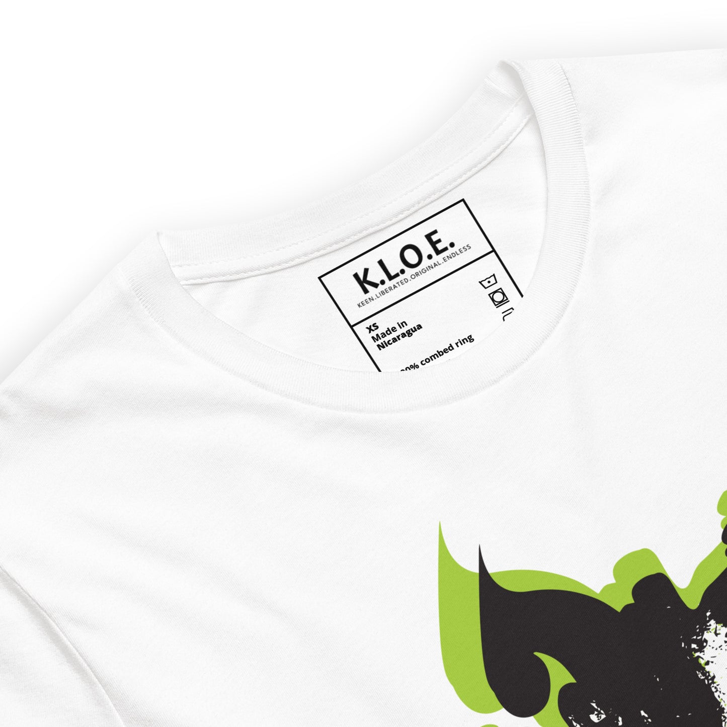 The inside label view of white K.L.O.E. T-shirt featuring a bold hand-drawn face design in black and vibrant green, surrounded by sharp, abstract patterns, celebrating individuality, artistic self-expression, and modern bohemian style fashion.