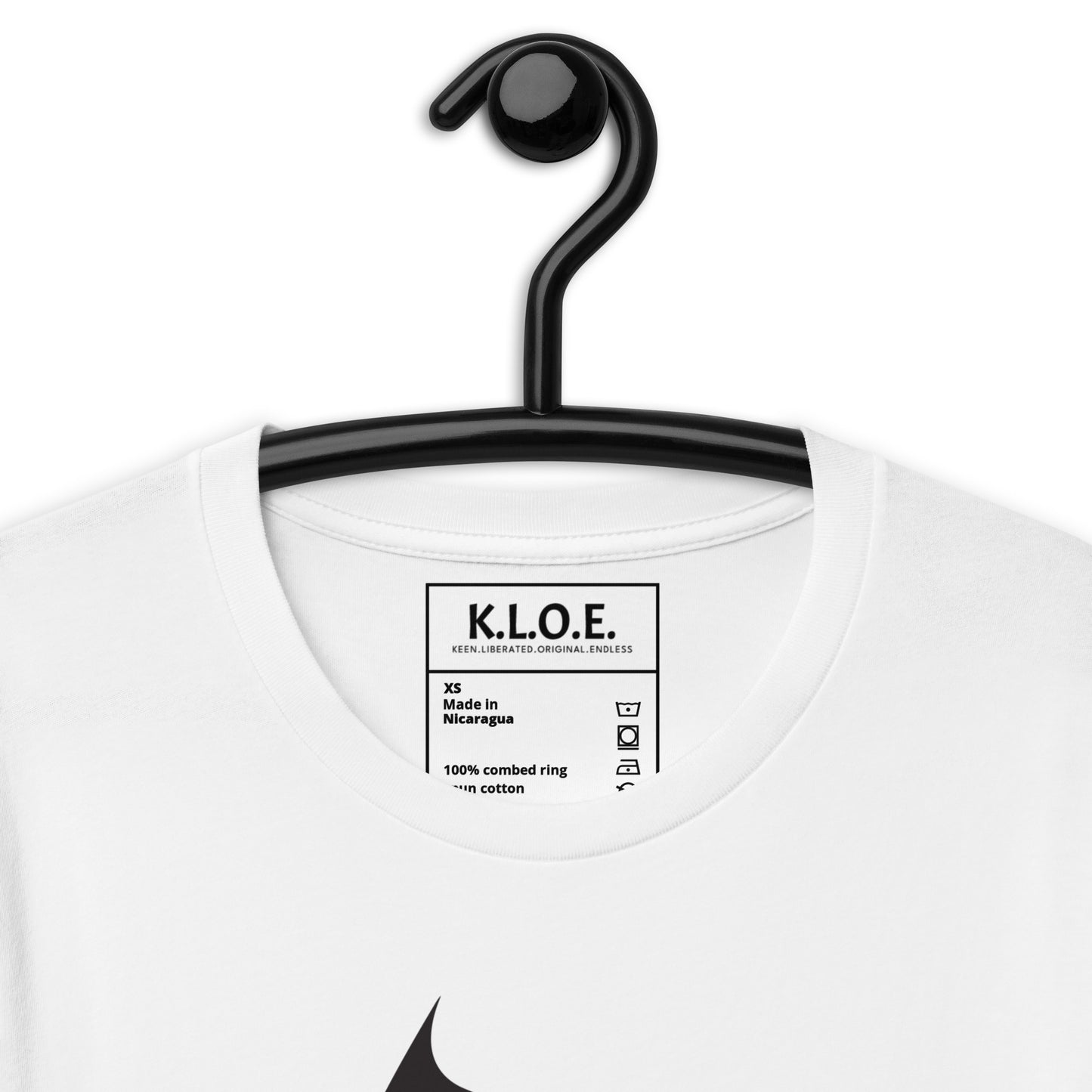 The view of the inside label of the white K.L.O.E. T-shirt featuring a culturally inspired, hand-drawn black graphic of a bold, expressive face surrounded by intricate details, celebrating individuality and artistic self-expression in modern bohemian style fashion.