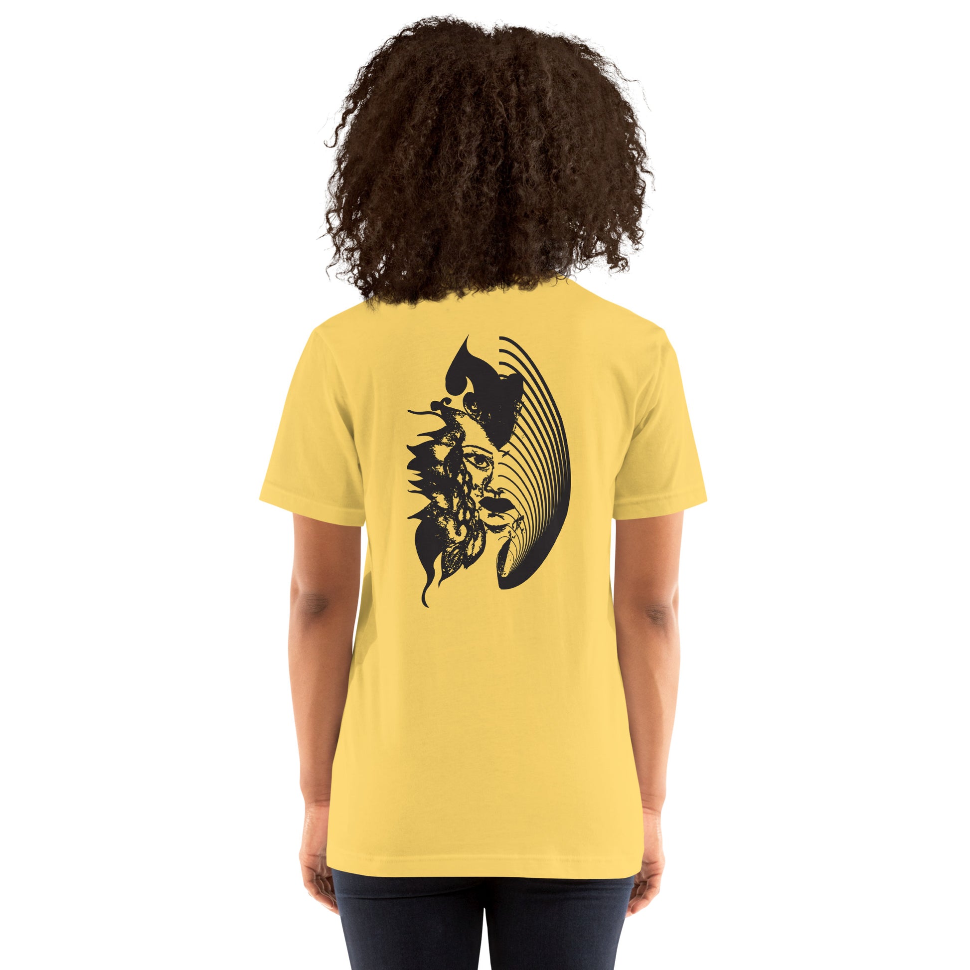 Back view of a yellow K.L.O.E. T-shirt showcasing a culturally inspired, hand-drawn black design featuring a bold, expressive face intertwined with flowing, abstract patterns, embodying artistic self-expression and modern bohemian style fashion, on a model.