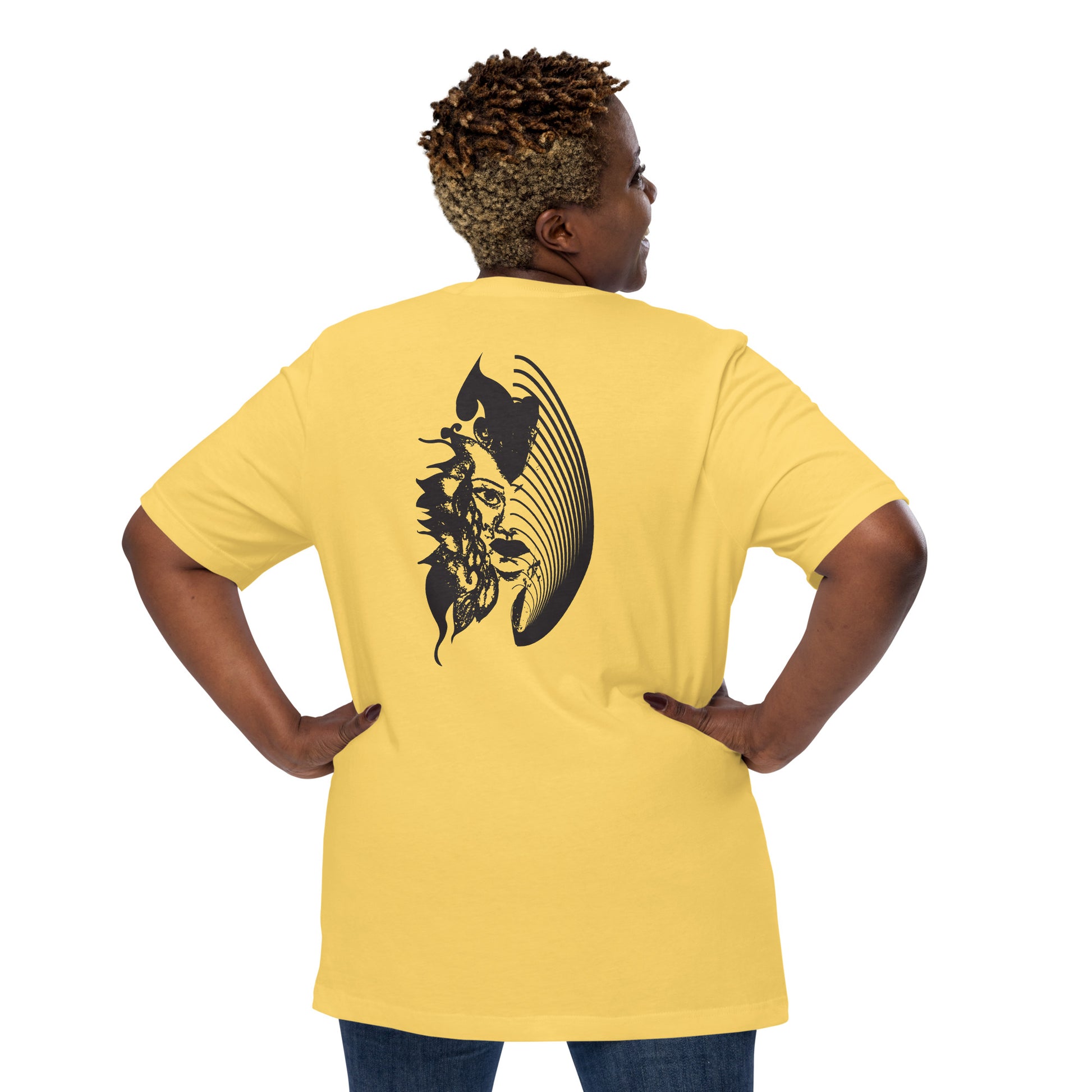 Back view of a yellow K.L.O.E. T-shirt showcasing a culturally inspired, hand-drawn black design featuring a bold, expressive face intertwined with flowing, abstract patterns, embodying artistic self-expression and modern bohemian style fashion, on a model.