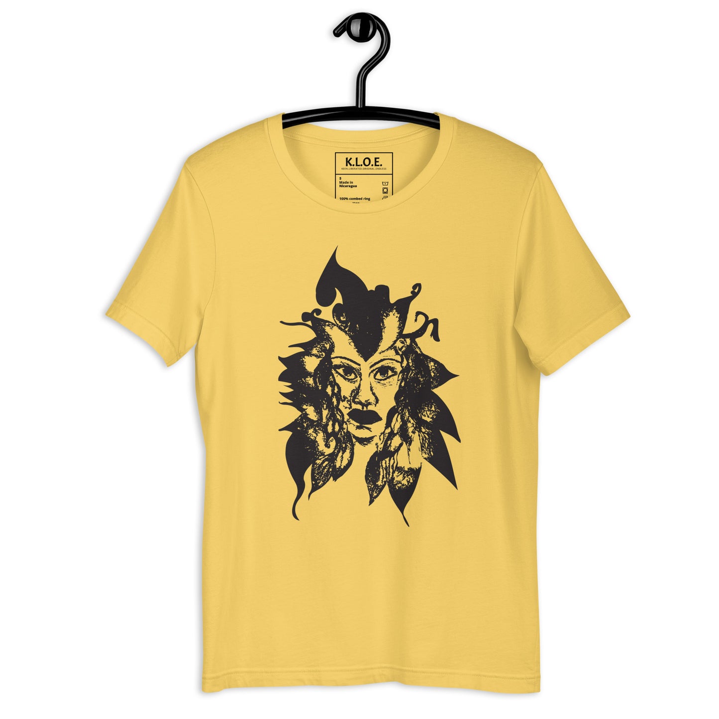 Yellow K.L.O.E. T-shirt featuring a culturally inspired, hand-drawn black graphic of a bold, expressive face surrounded by intricate details, celebrating individuality and artistic self-expression in modern bohemian style fashion.