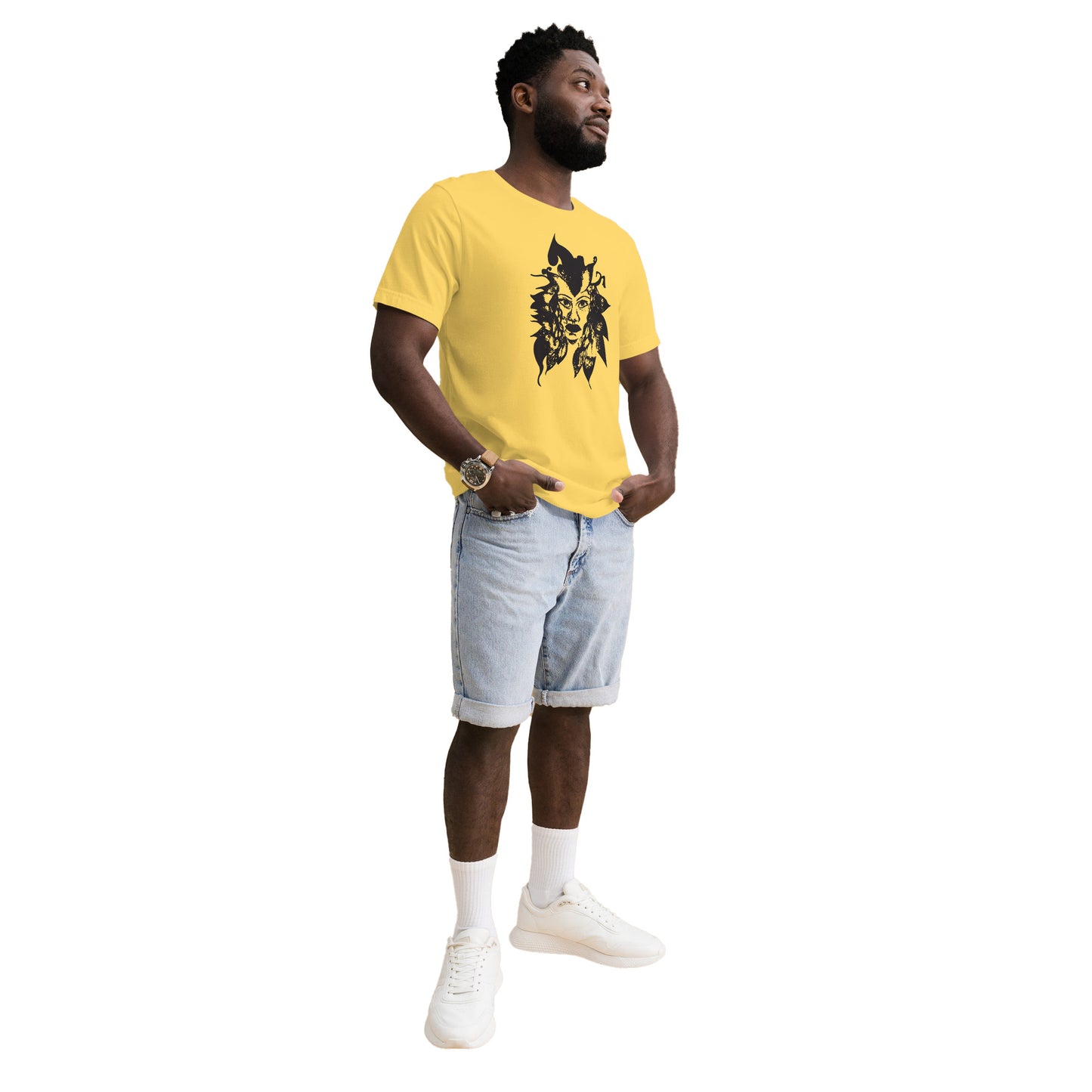 The model wearing yellow K.L.O.E. T-shirt featuring a culturally inspired, hand-drawn black graphic of a bold, expressive face surrounded by intricate details, celebrating individuality and artistic self-expression in modern bohemian style fashion.